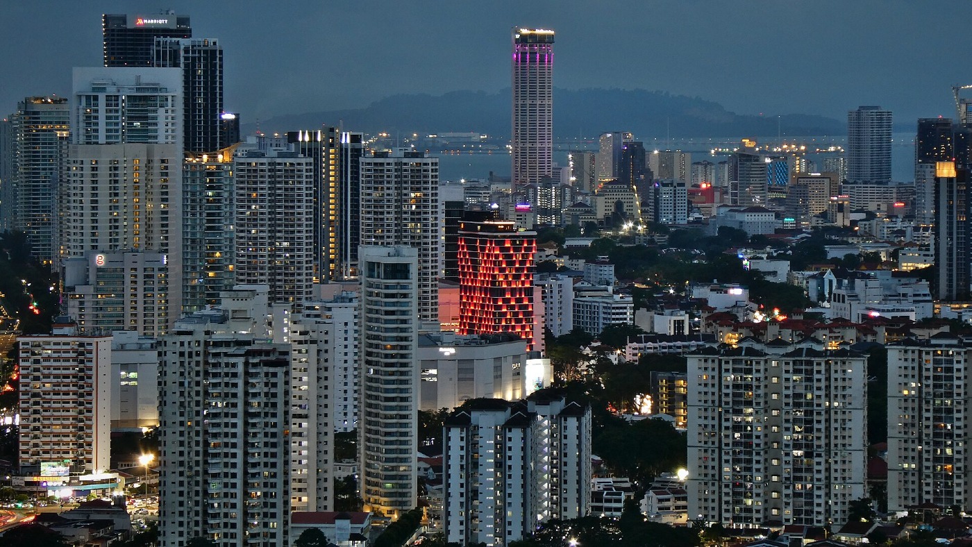 George Town's skyline in Penang at dusk, with the city lights coming on