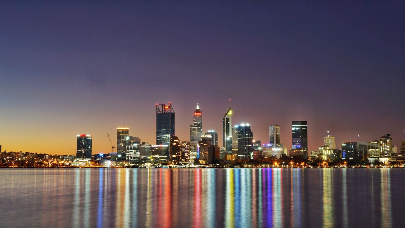 Perth city skyline at twilight, lights reflected in the Swan River